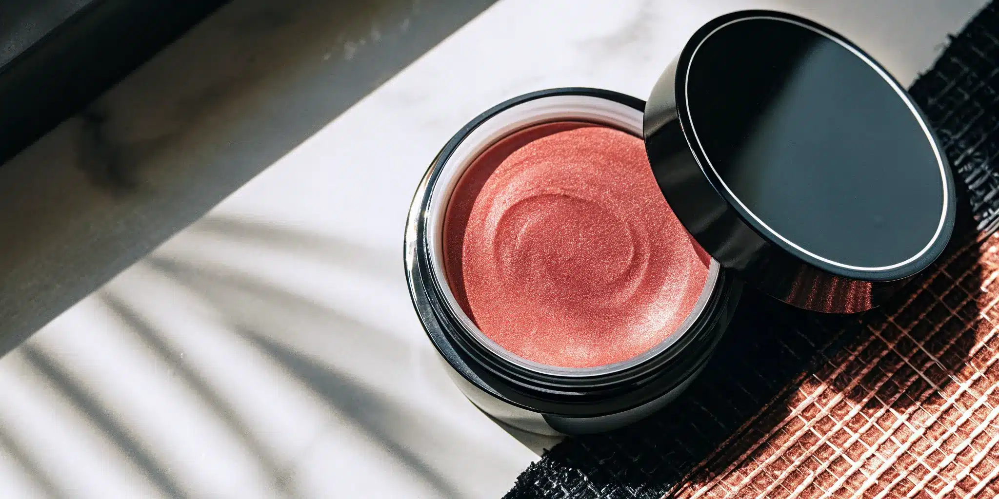 your-guide-to-mg-body-balm-what-it-is–why-it-works-747202 An open jar of Mg body balm for muscle comfort, relaxation, and skin hydration.